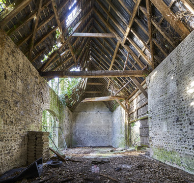 The interior of a dilapidated, collapsing old barn