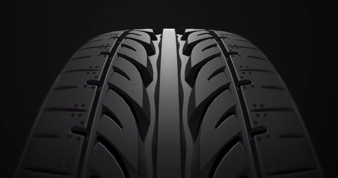 Close up car tire rotating slowly with depth of field