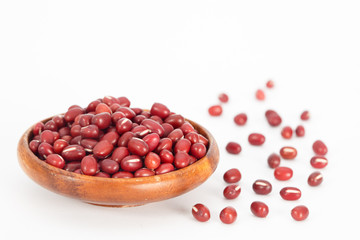 Red azuki beans in wooden bowl on white background. Vegan vegetarian healthy food.