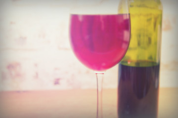 Bottle of red wine with glass ready to pour