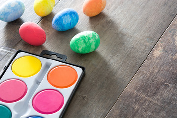 Painting Colorful Easter eggs on wooden background
