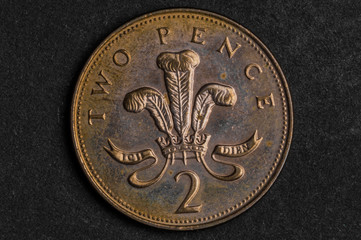 Close up of 2 two pence coin on black background - business concept