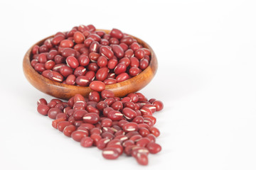 Red azuki beans in wooden bowl on white background. Vegan vegetarian healthy food.