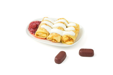 pancakes with sour cream, jam, chocolate candy, on a white background