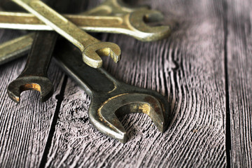 Tools for repairs on a wooden background