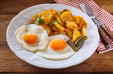 Two fried eggs with crispy roast potato