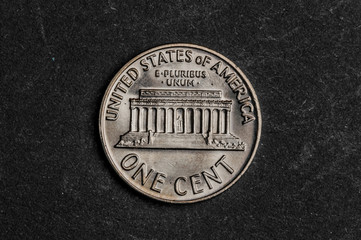 Close up of one american cent on black background - business concept