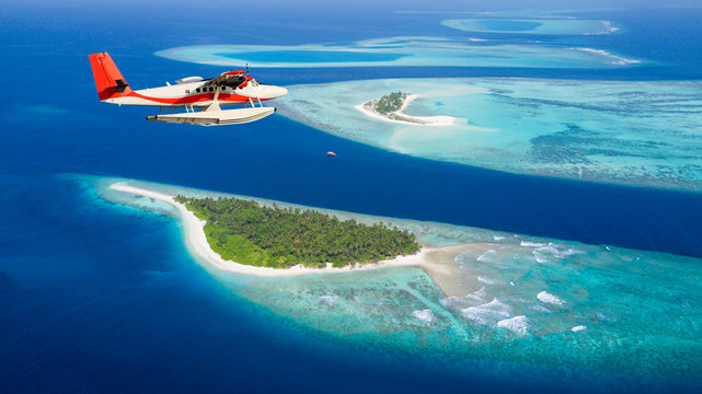 Fototapeta Sea plane flying above Maldives islands