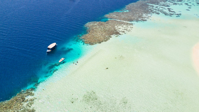 Beautiful coral reef with anchoring boats