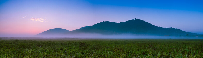 Valley in the morning mist in at the foothill of the mountains