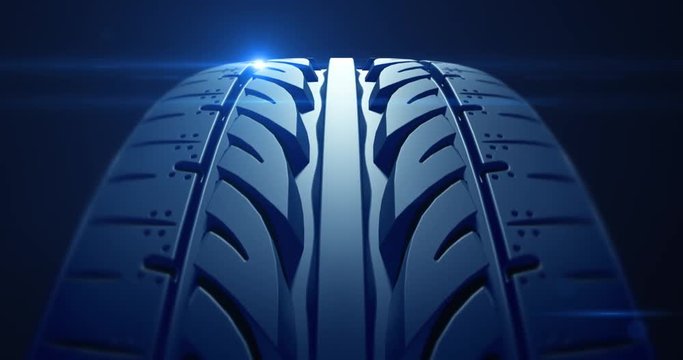 Close up car tire in slow motion with depth of field and lens flare