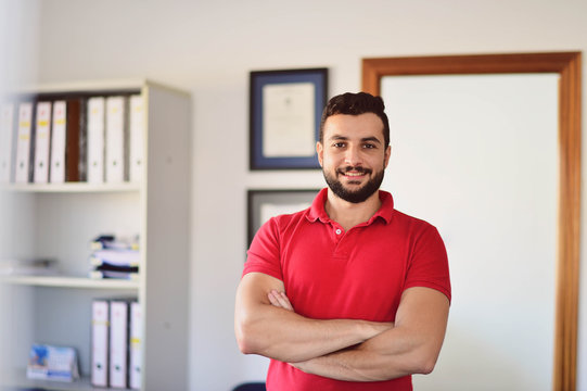 Man working in office posing for picture