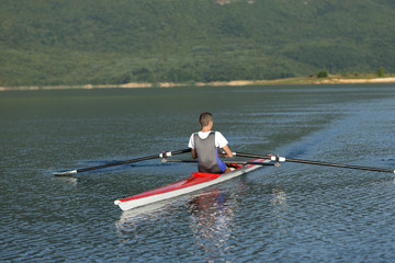 Child in the course of rowing on single