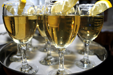 Focused glass of vermouth with a slice of lemon, thinly lined top of the glass with a layer of sweet sugar in the restaurant, Novi Sad, Serbia