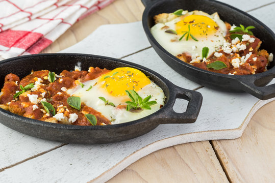 Shirred eggs with marinara and feta.