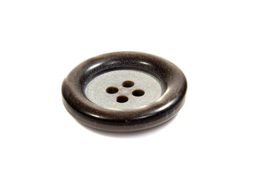 Single black clothing button isolated over the white background