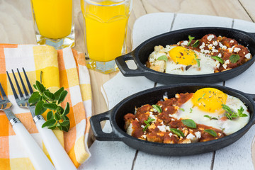 Breakfast with shirred eggs with marinara and feta.