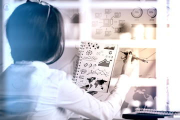 Woman drawing business graphs