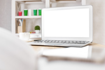 White laptop on office desktop