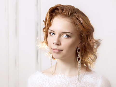 Portraits of a young bride on light background