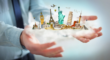 Businessman holding a cloud full of famous monuments in his hand