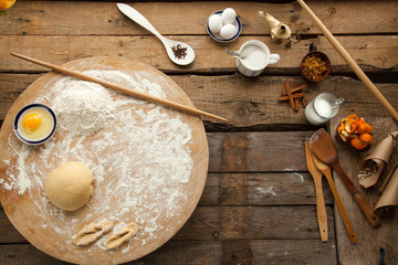 Prepared dough on wooden table with flour and egg. Cooking at home, best recipe for baking bread and pastry.