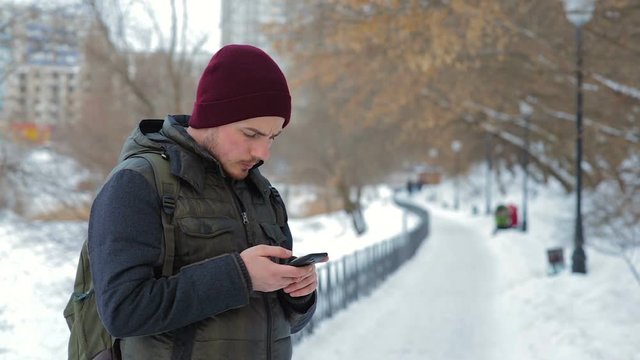 Young man using his smartphone outdoors