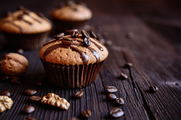 Coffee muffins with grated walnut and topped with chocolate