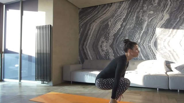 Happy and beautiful woman doing exercise of yoga at home.