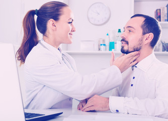 Man having consultation with female doctor in hospital