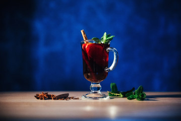 Mulled wine with slice of orange and spices. Shallow dof