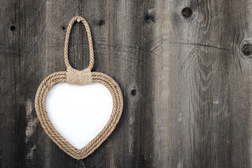 Frame heart handmade hanging on the dark wooden Board