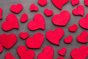 Red hearts on the wooden background.