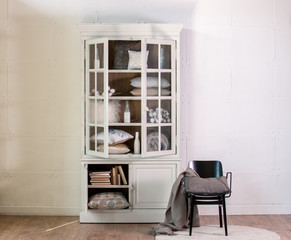 Fototapeta na wymiar steel wall tissue wooden cabinet linens and black metal chair