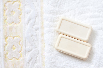 Two bars of soap on bath towel