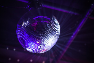 Disco ball with bright purple rays