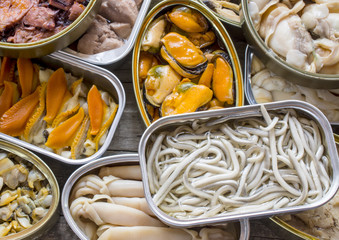 Assortment of cans of canned with different types of fish and seafood