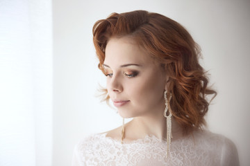 Portraits of a young bride on light background