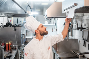 Chef cook checking the order at the restaurant kitchen