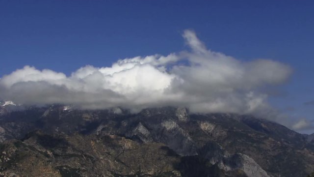 Clouds 1304: Time lapse clouds cast shadows on mountains.