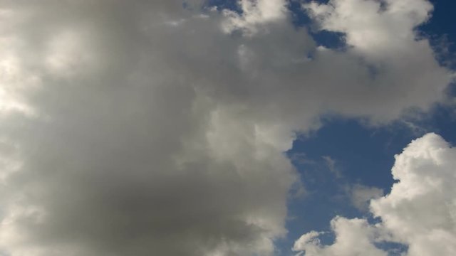 Clouds 1307: Time lapse white and gray clouds roil in a blue sky.
