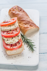 Sandwich with sliced fresh tomatoes and mozzarella