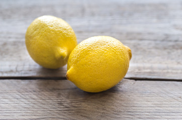 Fresh lemons on the wooden background