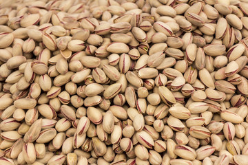 Roasted and salted pistachios as background