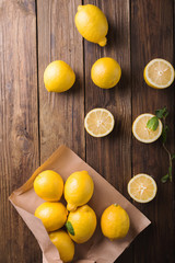 Lemons  on a wooden background. Lemons. Fruits. Lemon halves. Mint. Healthy food concept. Copyspace
