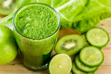 Green vegetable detox juice on wood table