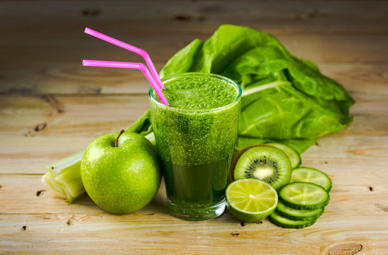 Green vegetable detox juice on wood table
