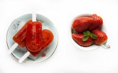 Strawberry popsicles 

On a plate with ice next to a bowl with strawberries