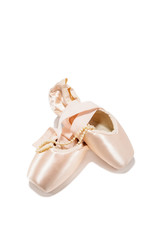 Ballet pointe shoes isolated over white background with pearl