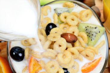 milk flow in bowl with cereal on table